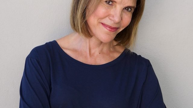 senior-woman-smiling-against-gray-wall-6H3V8QP.jpg